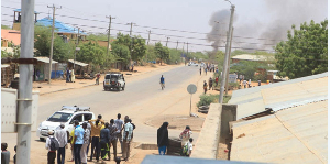 Residents of Mandera town watch as smoke rises from the neighbouring Somali town of Bula Hawa