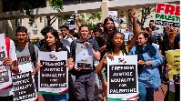 Demonstrators hold placards in support of Palestine in Stellenbosch, South Africa
