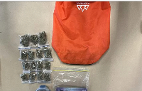 Items donated to a charity store, including marijuana and cash, are displayed in Southland