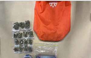 Items donated to a charity store, including marijuana and cash, are displayed in Southland