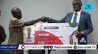 Kofi Adams (R), presenting the prize to one of the winners