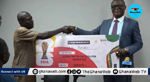 Kofi Adams (R), presenting the prize to one of the winners