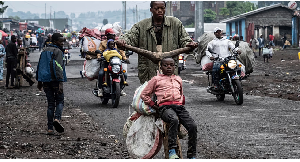 People displaced by the fighting with M23 rebels make their way to the center of Goma
