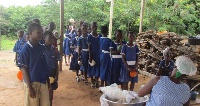 some pupils  queue up to be served with food