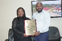 KK Peprah and wife,  Badu Akua Akoto displaying the citation