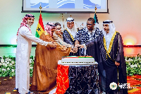 Deputy Minister among other dignitaries cutting the cake at the event