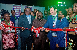 Dr Peter Boamah Otukunor (M) cutting the tape to open the summit