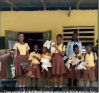 The school children pose for the cameras with their fowls