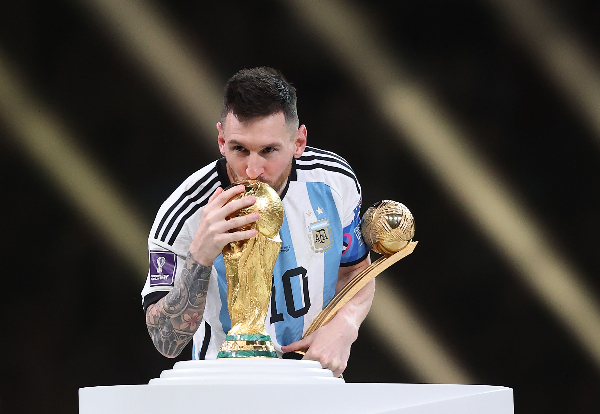 Lionel Messi kissing the World Cup trophy back in 2022