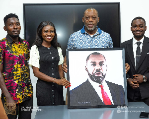 Dr Matthew Opoku Prempeh receives a framed portrait from the leadership of ALSA