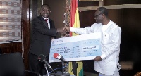 Alfred Baku,Head of West Africa, Goldfields (left) presents the $5.8m cheque to Ken Ofori Atta