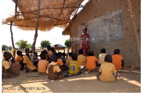 Pupils sit on the bare floor and learn under poor conditions