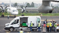 Officials prepare to load the bodies of the slain Italian ambassador to Democratic Republic of Congo