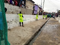 Some of the youth playing a match in the drain