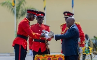 President Nana Addo Dankwa Akufo-Addo (right) handing over a sword to one of the graduates