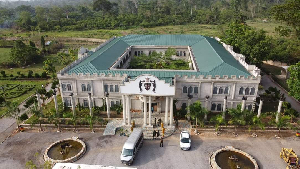 A bird's eye view shows the majestic Assin Kushea Palace surrounded by lush greenery