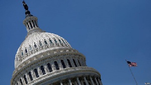 The US Capitol dome is reflected in a puddle on the ground, on September 29, 2025
