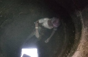 Body of the dead woman floating on the water in the well