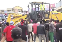 A file photo of protesters preventing officials from demolishing the market