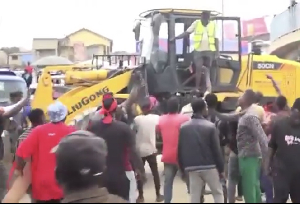 A file photo of protesters preventing officials from demolishing the market