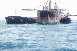 The Ship being loaded with manganese from the shuttle ship (right)