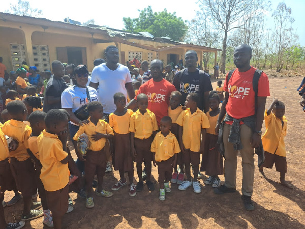 Volunteers from the foundation presenting the items to the school