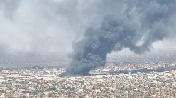 Drone footage shows birds in the foreground as clouds of black smoke billow over Bahri,