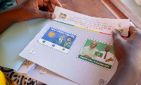 An electoral official prepares the presidential ballot papers at a polling station in Cotonou, Benin
