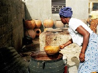 A woman brewing 'brukutu'