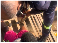 A file photo of a fire service personnel attempting to rescue the child