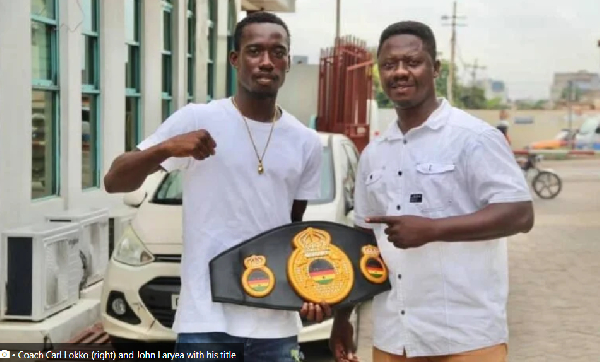 Coach Carl Lokko (right) and John Laryea with his title