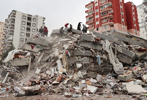 Rescue teams search through rubble of collapsed buildings in Turkey after a 7.8-magnitude earthquake