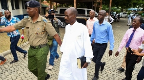 Detectives escort Ezekiel Ombok Odero for investigations