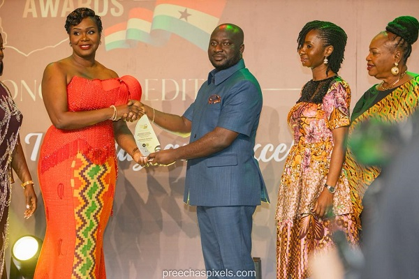 CEO of Veronique Heights, Lawrencia Sarhene (L), receiving her award