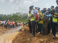 Officials spraying the Birim River