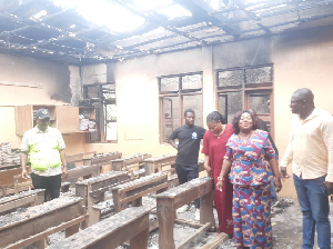 The Municipal Director of Education (2nd) right inspecting the burnt roof and store at Teshie