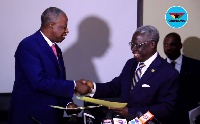 Osafo Maafo exchanges the agreement with his Ivorian counterpart after ITLOS ruling was implemented