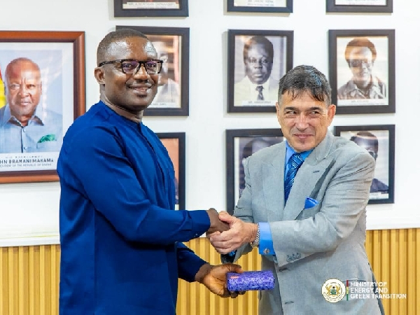 Energy minister (L) shaking hands with a member of AJC after the meeting