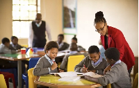 Picture of students in class with a teacher