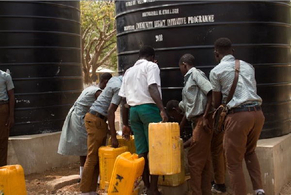 Students queuing to fetch water from a polytank