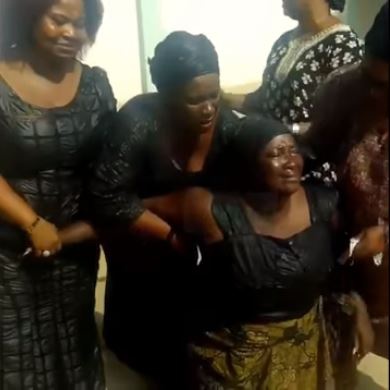 Ebony's mother  [3rd from left] wailing