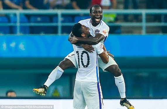 Frank Acheampong celebrating his goal with John Obi Mikel