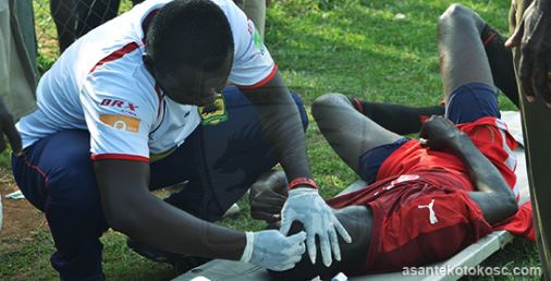 Kotoko's medic, Andrew Owusu treating one the BYA players.