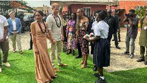 Prince Harry, Duke of Sussex and his wife Meghan, Duchess of Sussex, arrive to meet students