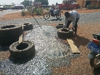 The vulcanizer  through his own initiative bought materials to cover potholes