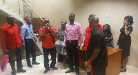 Staff of the National Labour Commission clad in red and black bands