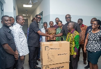 Rev. Sylvanus Sowah Odotei presenting the items to the hospital