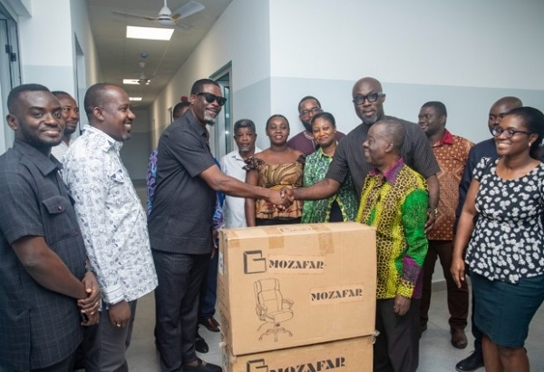 Rev. Sylvanus Sowah Odotei presenting the items to the hospital