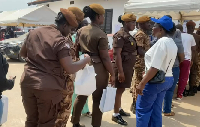 Some security officers receiving gifts during the Special Voting at Ayawaso West Wuogon