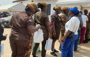 Some security officers receiving gifts during the Special Voting at Ayawaso West Wuogon